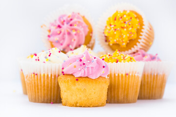 cupcake with pink frosting and sprinkles