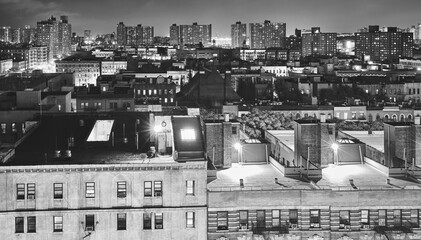 Black and white picture of Harlem neighborhood at night, New York City, USA.