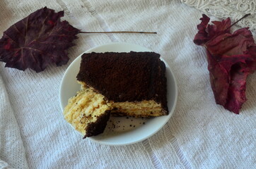 Ceramic coffee mug, dessert, old book and dry ears of wheat. Autumn layout.