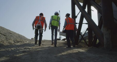 Inspectors walking on bridge construction site - Powered by Adobe
