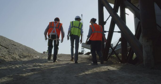 Inspectors walking on bridge construction site