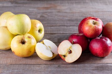 Ugly apple in a cut on a wooden background.. Ugly fruits concept