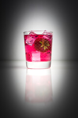 Homemade strawberry Liqueur in a glass with some fresh fruits