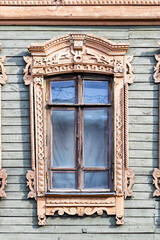 Fototapeta na wymiar Gingerbread wood trims. Window decoration of an old green wooden house
