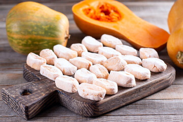Homemade pumpkin gnocchi uncooked on the wooden board. Homemade Sweet pumpkin Dumplings or Gnocchi