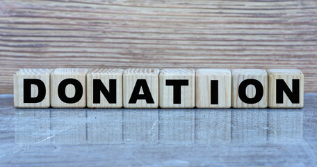 DONATION - word on wooden cubes on a gray background