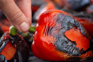Red peppers roasting on a wood-fired stove