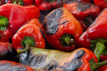 Red peppers roasting on a wood-fired stove