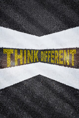 Think different words on asphalt. Out of box concept and business challenge idea