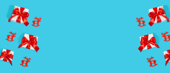 Merry Christmas and Happy Holidays postcard, frame, banner. New Year. Gift boxes on a light blue background with Christmas decorations. Winter holiday theme. Flat lay