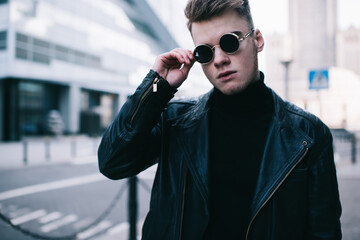 Stylish young man in black leather coat