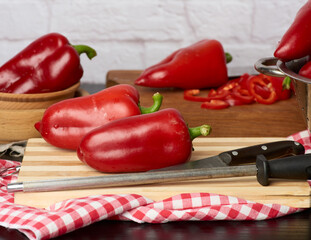 fruits of ripe red pepper on a wooden cutting board