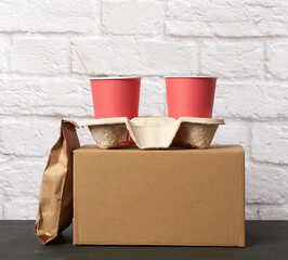 red paper disposable cups stand in the tray, white background