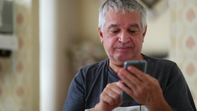 Older man reacting positively to information on smartphone