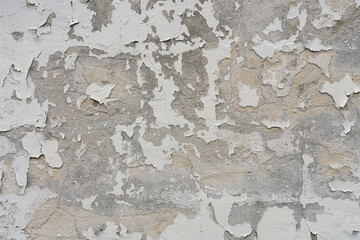 Close up of concrete wall with texture of white paint peeling off