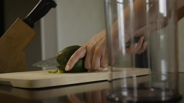 Woman cutting mango on the table