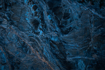 Blue stone background. Toned rock texture. Macro. Marble effect.