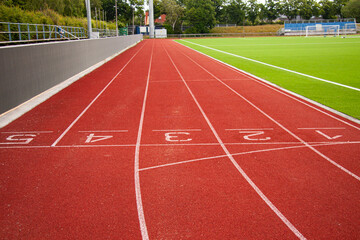 Athletic running track in a stadium with start point positions numbers one two, three, four five....