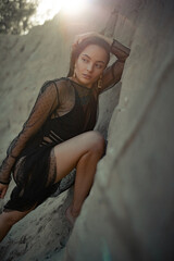Obraz premium Pretty woman poses in sand canyon.