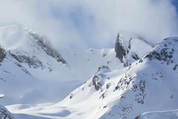 Fototapeta na wymiar Snowy misty winter landscape in high mountains