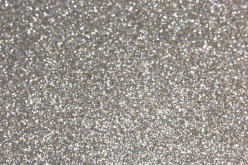 Silver abstract defocused bokeh background. Sparkling texture.