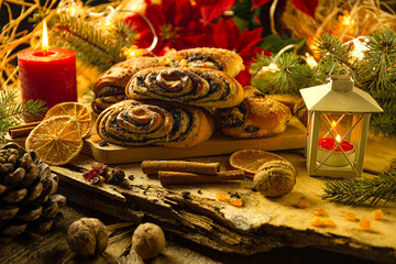 Christmas Makowiec cake and candle on wooden table