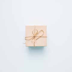 present gift box wrapped with craft paper and ribbon