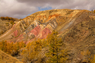 Amazing multi-colored mountains. Sandstone erosion, unusual colored rocks. Rainbow mountains in Altai.
