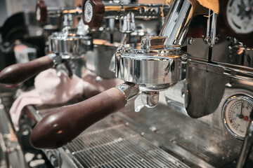 Close up of professional coffee machine. Brown handles and chrome surfaces of coffee machine