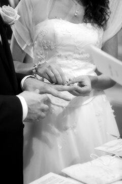 Bride and groom at the exchange of rings, black and white image
