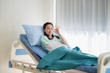Asian female patients recuperate at hospital, bright, relaxed and happy face.