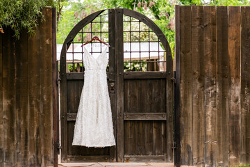 white wedding dress hanging on wall or window