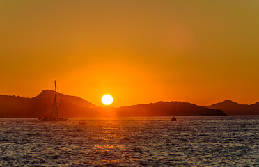 Boat sailing at sunset