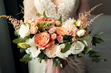 Beautiful wedding bouquet in bride's hands. Wedding decor.