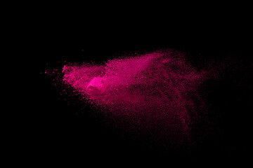 Pink powder explosion on black background. Colored cloud. Colorful dust explode. Paint Holi.