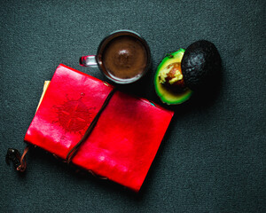 A diary, a coffee and a avocado