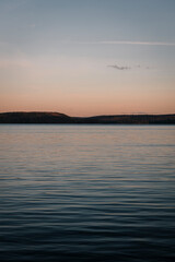 Sunset by the lake. Captured this image in Algonquin park overlooking the lake while the sun is setting in the distance creating this beautiful display of colors. 