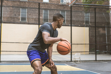 Naklejka premium Basketball player training outdoors
