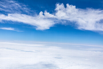 Clouds and sky as seen through window of an aircraft.