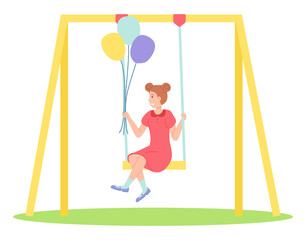 Girl holding bunch of balloons swinging on a slide swing at the playing field. Happy cartoon kid playing in playground on the backyard. Childrens summer playground . Kids summer outdoor activities