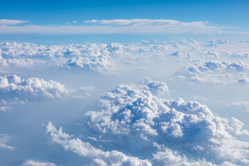 Clouds and sky as seen through window of an aircraft.