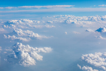 Clouds and sky as seen through window of an aircraft.