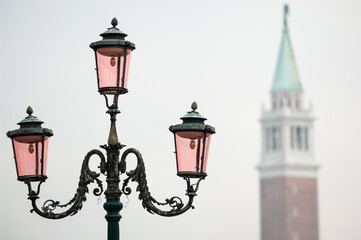 Fototapeta na wymiar Ornate Lamp and the Bell Tower of San Giorgio Maggiore Church in the Mist, Venice, Italy