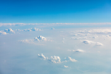 Clouds and sky as seen through window of an aircraft.