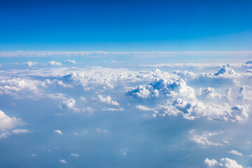 Naklejka na ściany i meble Clouds and sky as seen through window of an aircraft.
