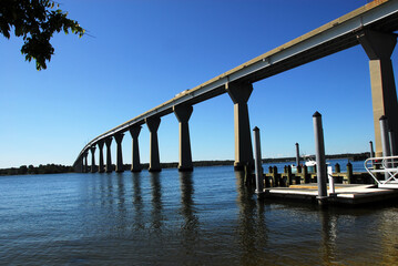 Gov. Thomas Johnson Bridge, by the public boat ramp and fishing pier near Solomons Island, Maryland. Looking southwest towards St. Mary's County. Located in Calvert Co. adjacent to the Patuxent River. - obrazy, fototapety, plakaty