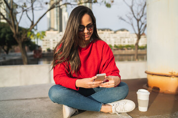 Young woman using her mobile phone.