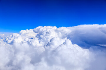 Clouds and sky as seen through window of an aircraft.