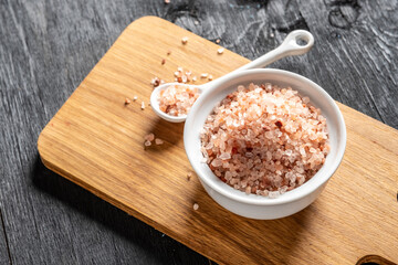 Himalayan salt in white bowl on wooden.