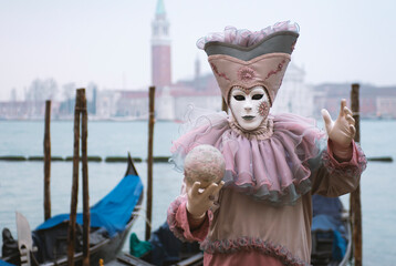 Beautiful mask with gondolas during the carnival in Venice